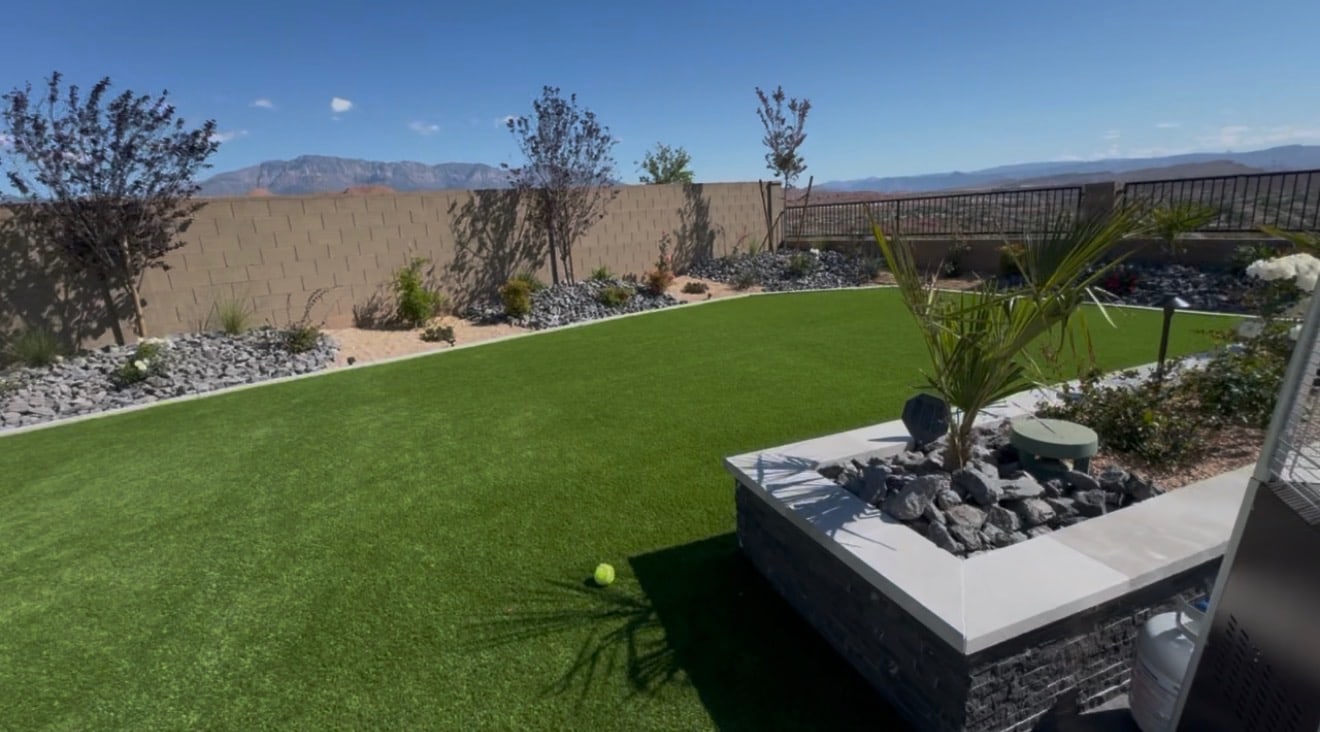 Turf lawn with rock borders and a raised masonry planter